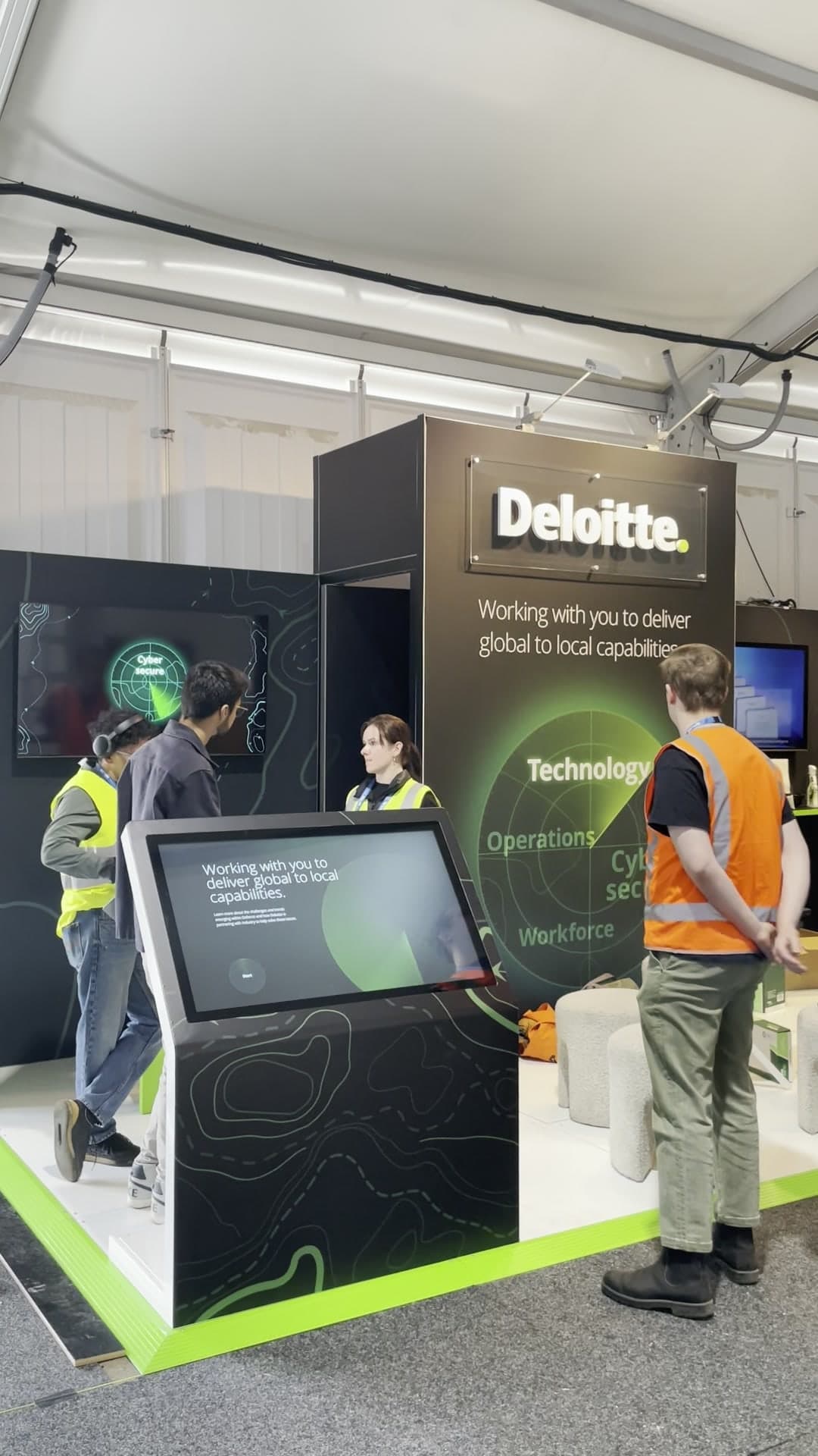The animated Avalon Industry Playbook opening screen running on the large angled touchscreen within the Deloitte activation.