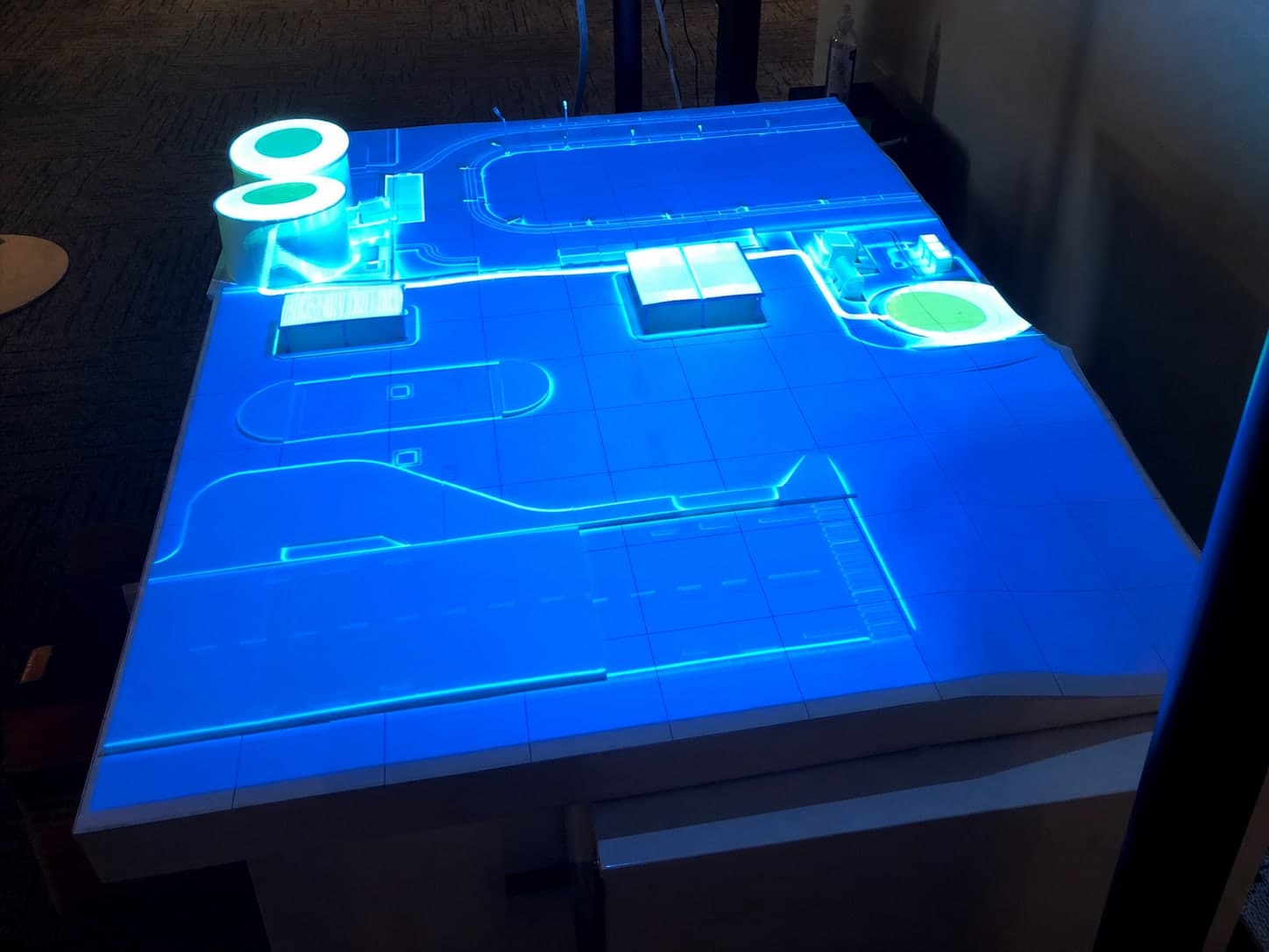 Anonymous cropped view of blue projection mapped across a later physical fuel-management prototype.